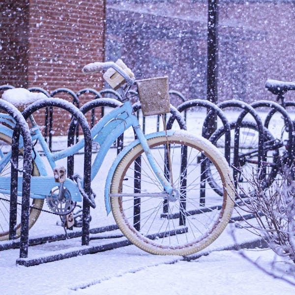 Snow Covered Bikes Parked Outside University Tower