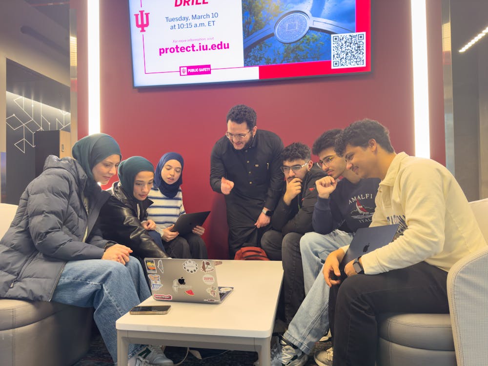 "One Table, Many Traditions" organizers Waad Al-Hbeish (left), Ayah Mahariq (left middle), Noura Aly (left right), Tamer Alsalloum (middle), Adam Tayeh (right left), Omar Tayar (right middle) and Peter Remala (right) meet on March 4, 2026, to prepare for their co-hosted event. (Photo courtesy of Peter Remala)