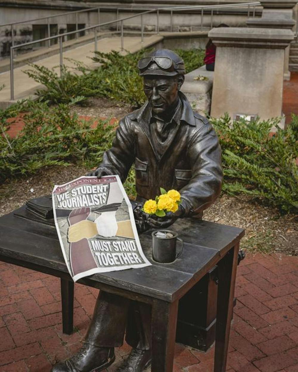 The statue of Pulitzer Prize-winning war correspondent and Indiana Daily Student alum Ernie Pyle holds a copy of The Purdue Exponent’s IDS solidarity edition. By Charlie Stapleton - provided by The Purdue Exponent