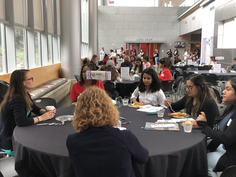 <p>Women in Tech brunch attendees speak with representatives from Moser Consulting.﻿</p>
