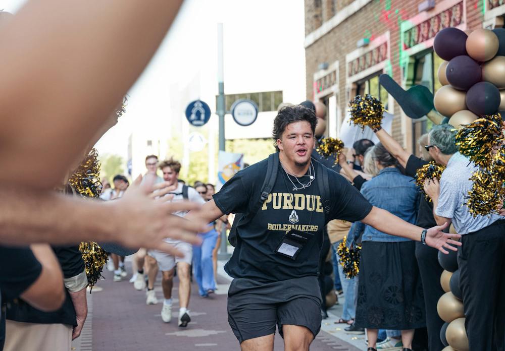 Freshmen run the Welcome Tunnel in front of the Madam Walker Legacy Center in Indianapolis during the 2026 Boiler Gold Rush. (Photo courtesy of Purdue University)