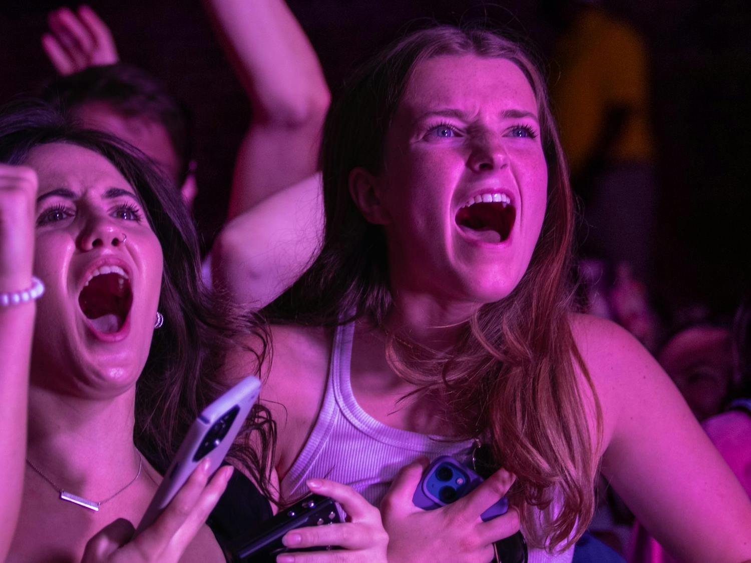 Two students scream in excitement during COIN's performance at Cockstock on Oct. 6, 2023. The band told the crowd to jump, and most members of the audience joined in.