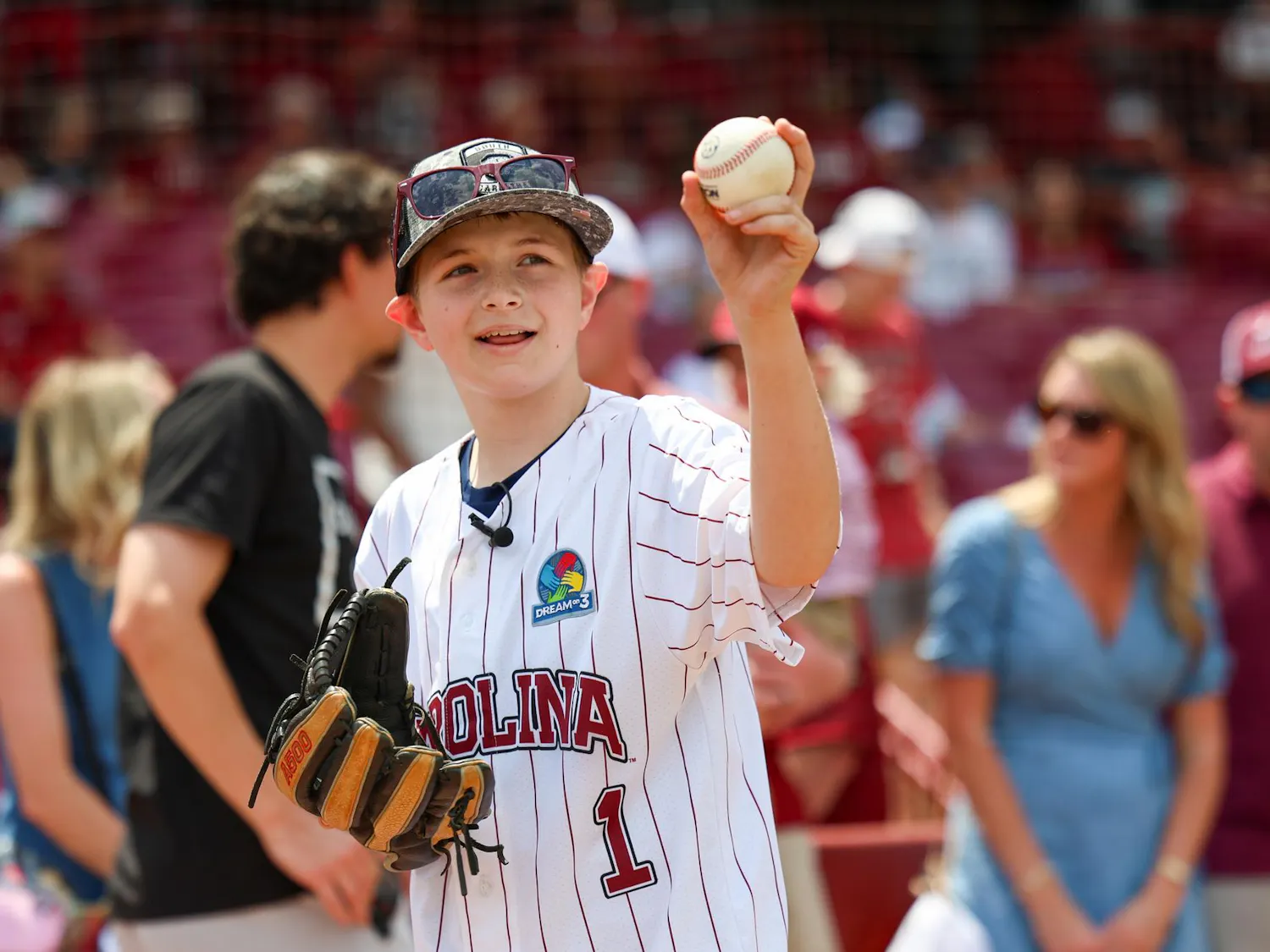Lexington resident Gabriel Lyons holds up a baseball before throwing the ceremonial first pitch before the baseball game between South Carolina and Kentucky at Founders Park on April 25, 2026. Lyons, who has autism, was given the opportunity to throw the first pitch by Dream on 3, a nonprofit who partners with universities to give special experiences to kids with learning disabilities.