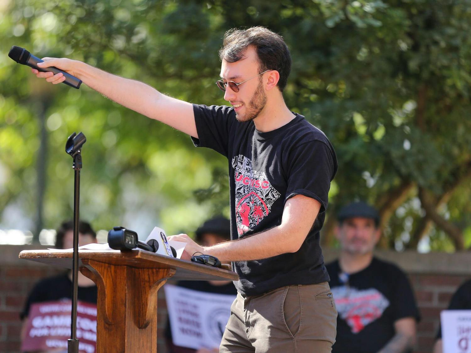 Union organizer AD Foster completes a call and response with those in attendance during a USC worker speak-out event held on the Russell House patio on Oct. 26, 2023. The event was hosted by United Campus Workers union at USC.