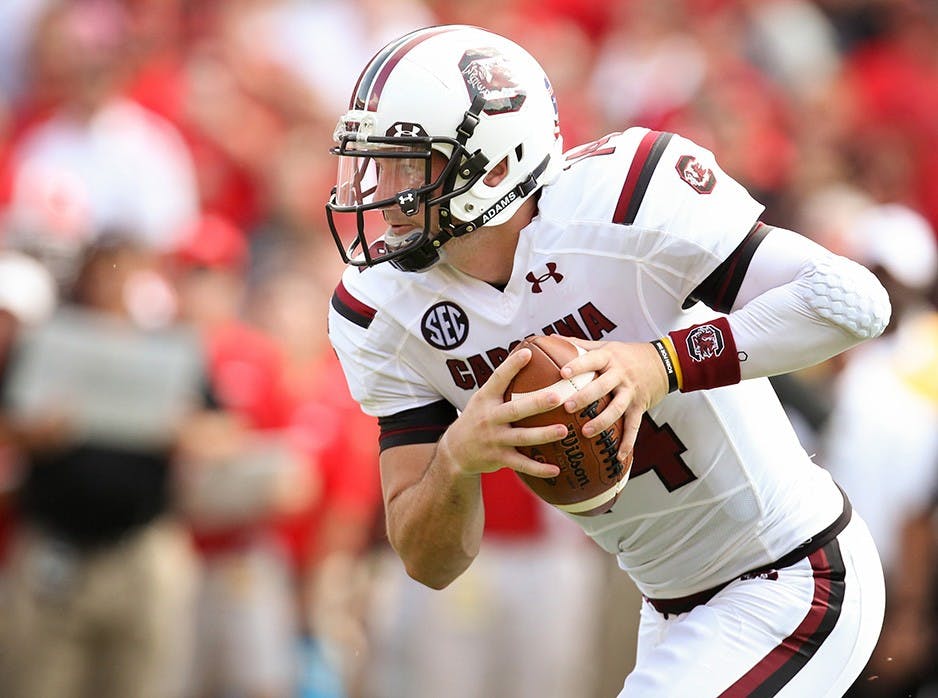 Connor Shaw, the starting quarterback from 2010 to 2013, carrying the ball down the field. Shaw is the winningest quarterback in school history and is one of the 10 new members being added to the South Carolina Athletics Hall of Fame in October.
