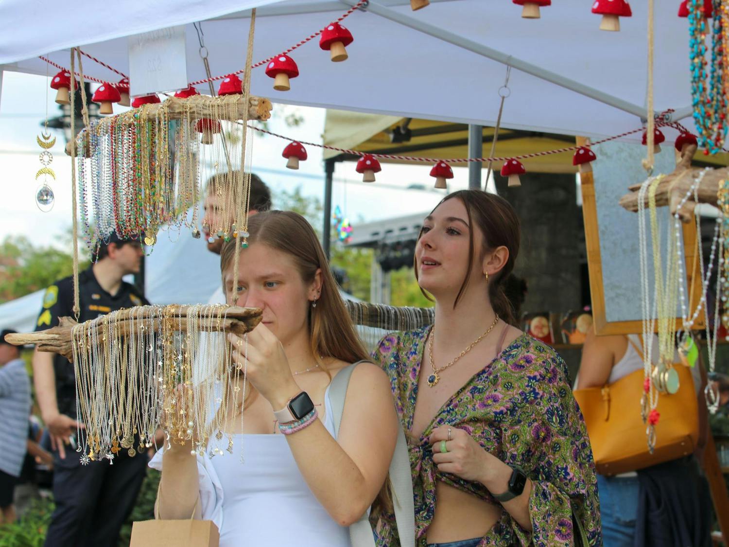 Angel Pavlick looks at a collection of necklaces for sale at one of the vendors at JerryFest on Oct. 6, 2024. Pavlick, who just moved from Indiana, said she wanted to check everything out. 