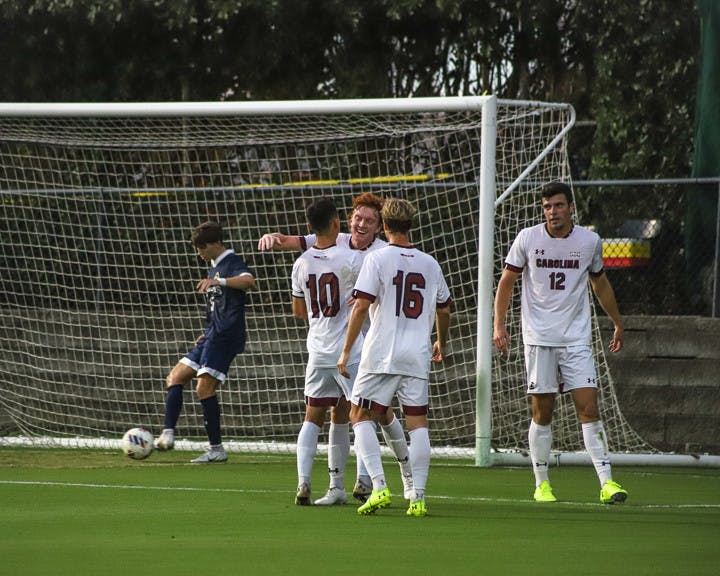 Teammates congratulate junior forward Adam Luckhurst after he makes a goal. Luckwurst scored two out of three points for South Carolina on Sept. 20, 2022. The Gamecocks beat Queens University 3-1.