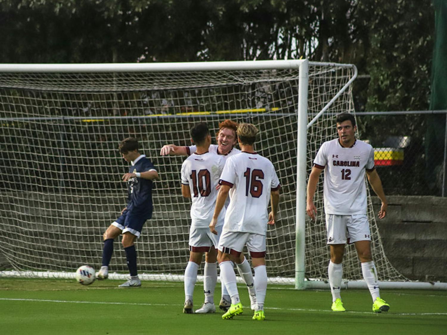 Teammates congratulate junior forward Adam Luckhurst after he makes a goal. Luckwurst scored two out of three points for South Carolina on Sept. 20, 2022. The Gamecocks beat Queens University 3-1.