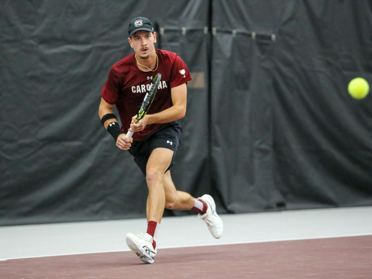 Graduate student Raphael Lambling eyes the ball for a return during South Carolina’s match against Georgia at the Carolina Indoor Tennis Center on April 7, 2023. The Gamecocks lost to the Bulldogs 4-0.