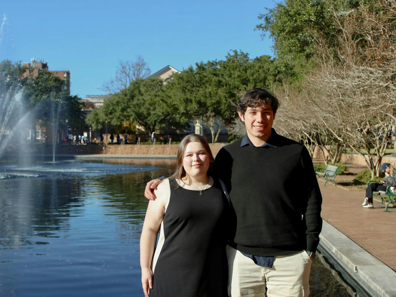 Fourth-year finance student Eleanor McMakin and third-year economics student Dan Contreras pose in front of the Thomas Cooper water fountain on Nov. 14, 2025. McMakin and Contreras got the chance to be chosen as Navigators by the United Nations Research Institute for Social Development and will be able to travel around the world.