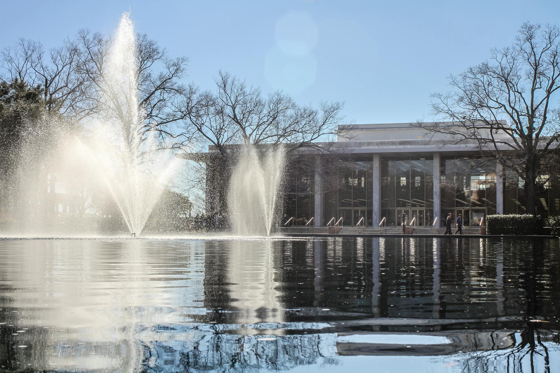 Three fountains spring up from the reflecting pool in front of the Thomas Cooper Library at the University of South Carolina on Feb. 4, 2023. The fountain and reflecting pool are one of many green spaces on campus.
