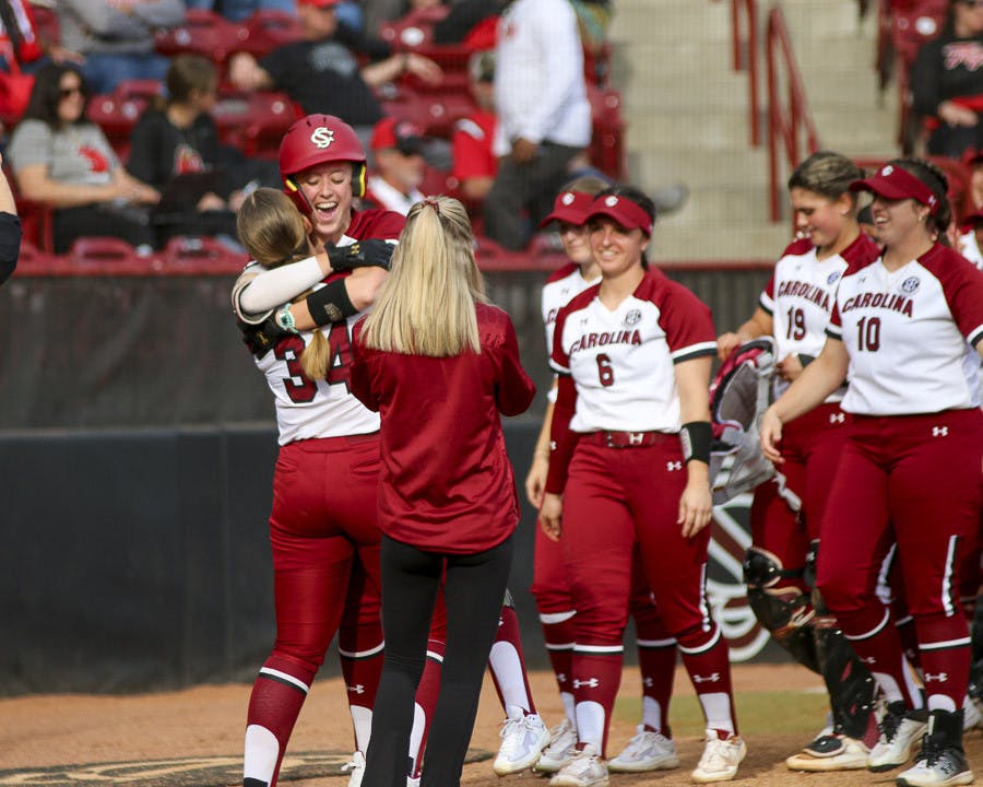 The Gamecock softball team celebrates after fifth-year outfielder Haley Simpson hits a home run during the second inning of the match against Western Kentucky University at Beckham Field on Feb.19, 2023. The Gamecocks defeated the Hilltoppers 11-2.