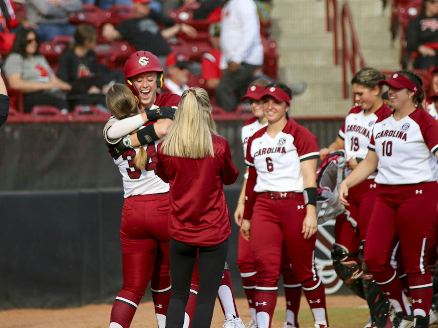 The Gamecock softball team celebrates after fifth-year outfielder Haley Simpson hits a home run during the second inning of the match against Western Kentucky University at Beckham Field on Feb.19, 2023. The Gamecocks defeated the Hilltoppers 11-2.