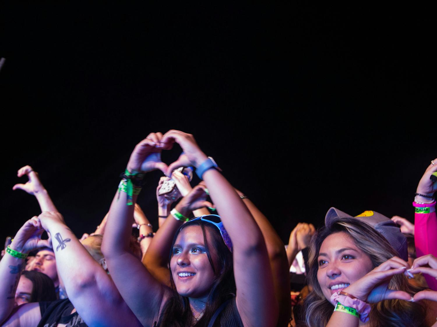 A fan throws up a heart shape during NGHTMRE’s set at Hidden City Music Festival on April 22, 2023. The artist gave multiple affirmations of his love and appreciation to his fans.&nbsp;