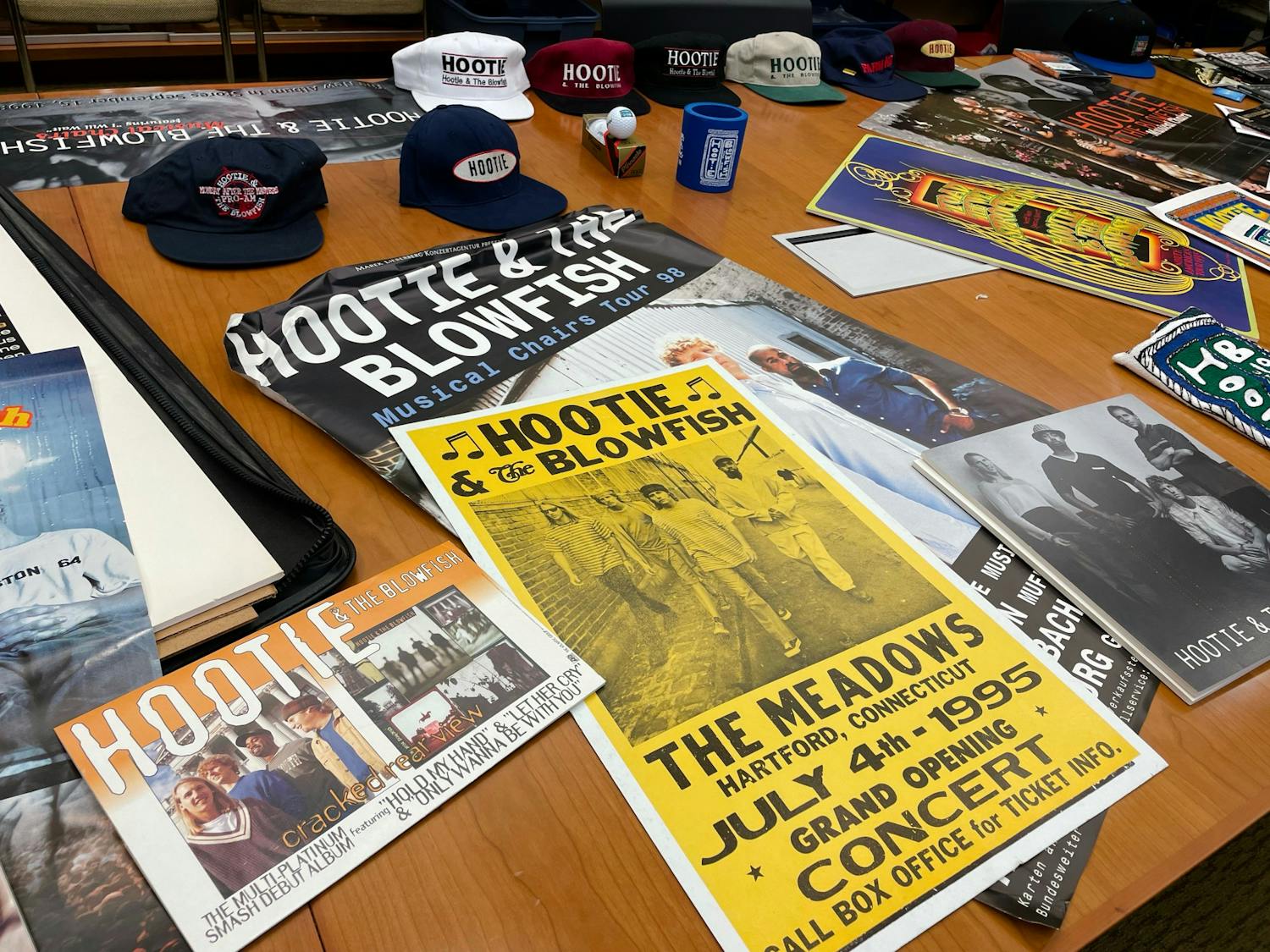 A table of Hootie &amp; the Blowfish memorabilia on June 3, 2022. The collection is being added to 鶹С򽴫ý's special collections library and contains items such as hats, posters and a guitar signed by each of the band members.