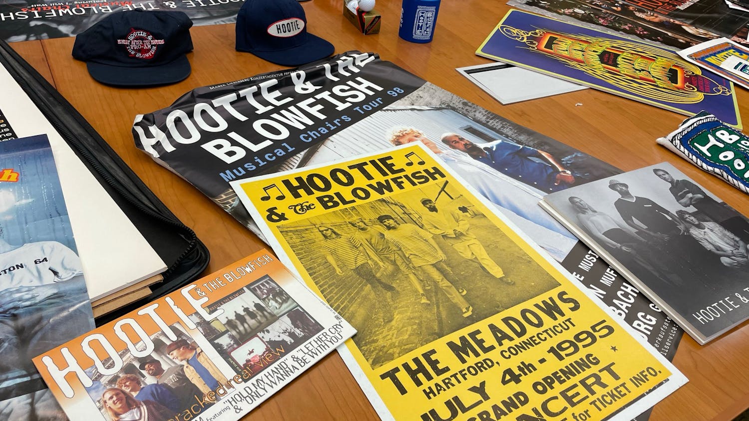 A table of Hootie & the Blowfish memorabilia on June 3, 2022. The collection is being added to USC's special collections library and contains items such as hats, posters and a guitar signed by each of the band members.