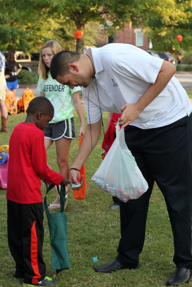 Michael Marroquin a third-year information technology sciences major gives Jeremy Green a piece of candy after scoring a soccer goal.