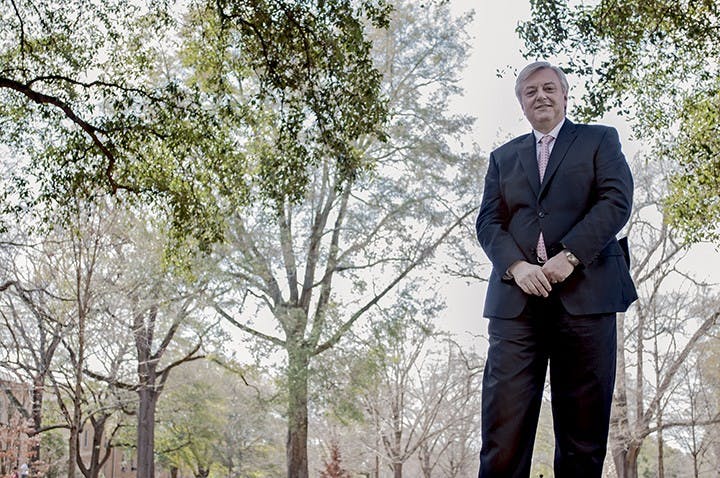 A photo of President Michael Amiridis in front of a nature scene.
