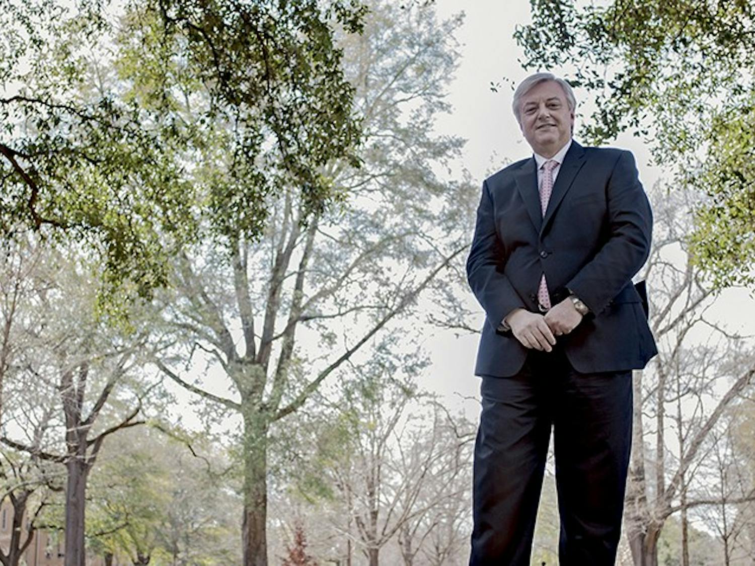 A photo of President Michael Amiridis in front of a nature scene.
