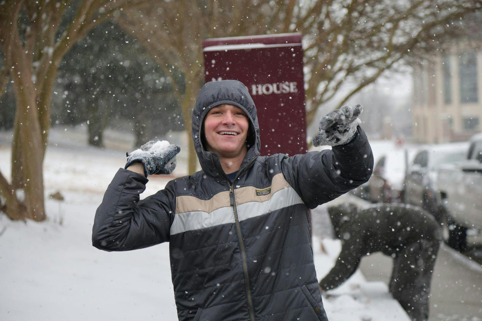 First-year biochemistry and molecular biology student Ryan Ezekiel prepares to throw a snowball outside Campus Village during snowfall on Jan. 31, 2026. Students took advantage of the rare winter weather to gather and play in the snow across campus.