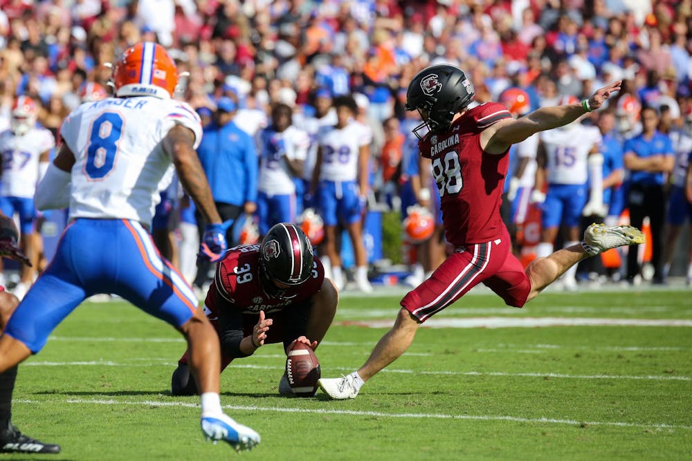 <p>Senior placekicker Mitch Jeter kicks a ball held by senior punter Kai Kroeger after a touchdown during South Carolina’s 41-39 loss to Florida on Oct. 14, 2023 at Williams-Brice Stadium. The Gamecocks finished the 2023 season with a record of 5-7.</p>
