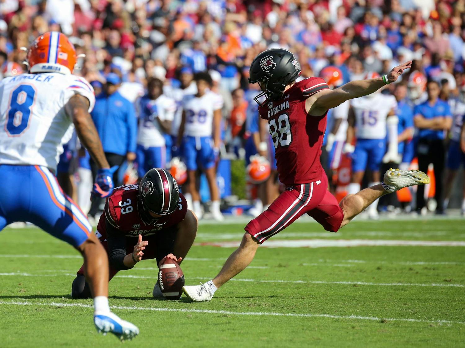 Senior placekicker Mitch Jeter kicks a ball held by senior punter Kai Kroeger after a touchdown during South Carolina’s 41-39 loss to Florida on Oct. 14, 2023 at Williams-Brice Stadium. The Gamecocks finished the 2023 season with a record of 5-7.