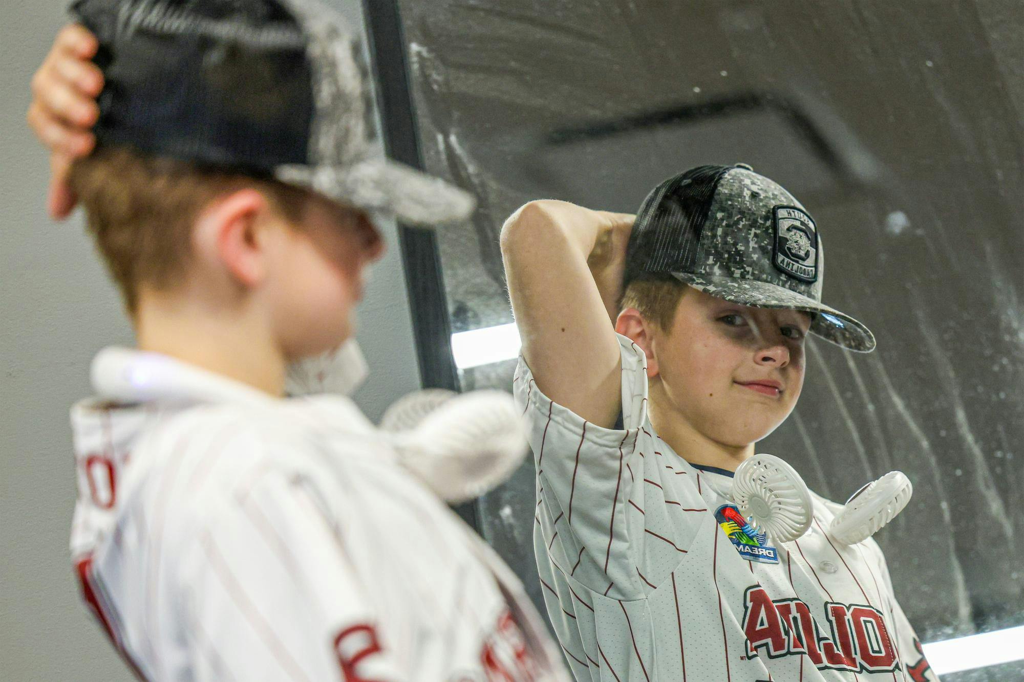 Lexington resident Gabriel Lyons looks into a mirror during a guided tour at Williams-Brice Stadium on April 25, 2026. Lyons, who has autism, was given a tour of the stadium and other athletics facilities as part of a dream weekend organized by Dream on 3.