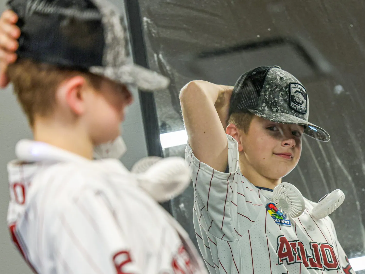 Lexington resident Gabriel Lyons looks into a mirror during a guided tour at Williams-Brice Stadium on April 25, 2026. Lyons, who has autism, was given a tour of the stadium and other athletics facilities as part of a dream weekend organized by Dream on 3.