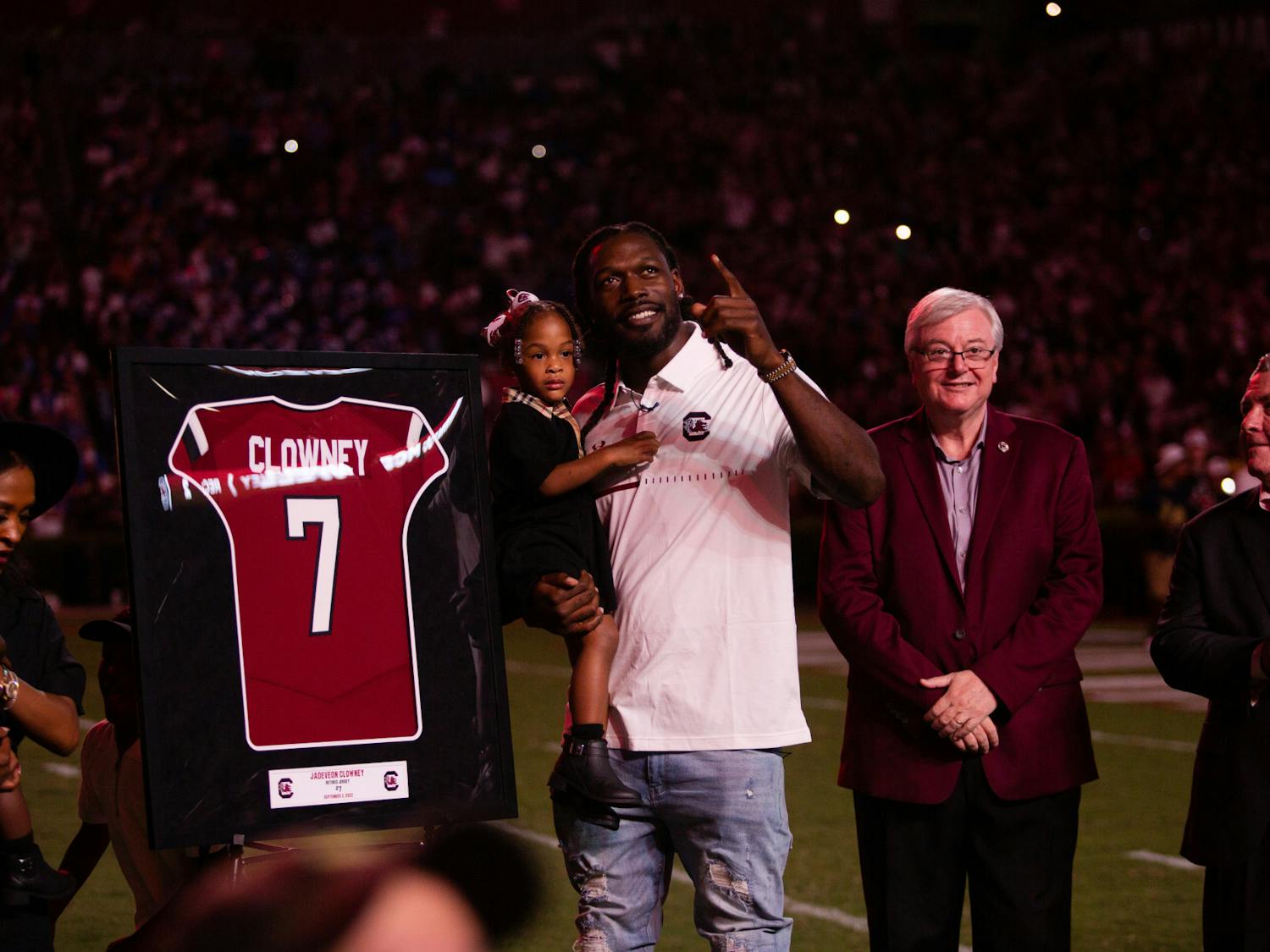 Jadeveon Clowney, a former Gamecock defensive end, points at a new sign of his name. Clowney's jersey was retired during the game against Georgia State on Sept. 3, 2022.  