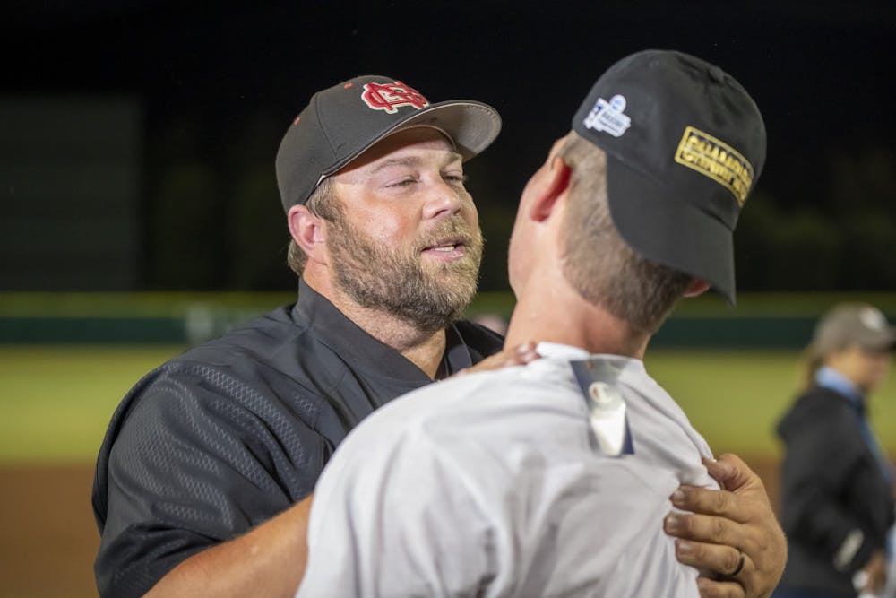 <p>North Greenville head coach Landon Powell celebrates winning the DII baseball national championship with redshirt junior shortstop Cory Bivins on June 10, 2022. North Greenville defeated Point Loma 5-3.</p>