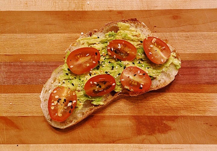 &nbsp;A piece of toast topped with avocado and tomato.&nbsp;