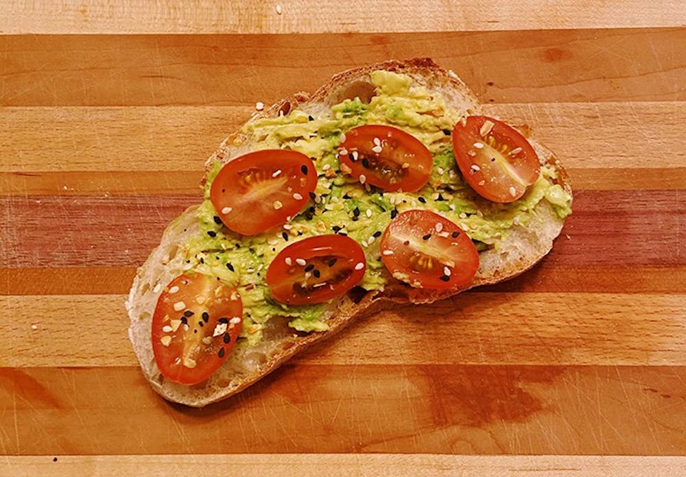 <p>&nbsp;A piece of toast topped with avocado and tomato.&nbsp;</p>