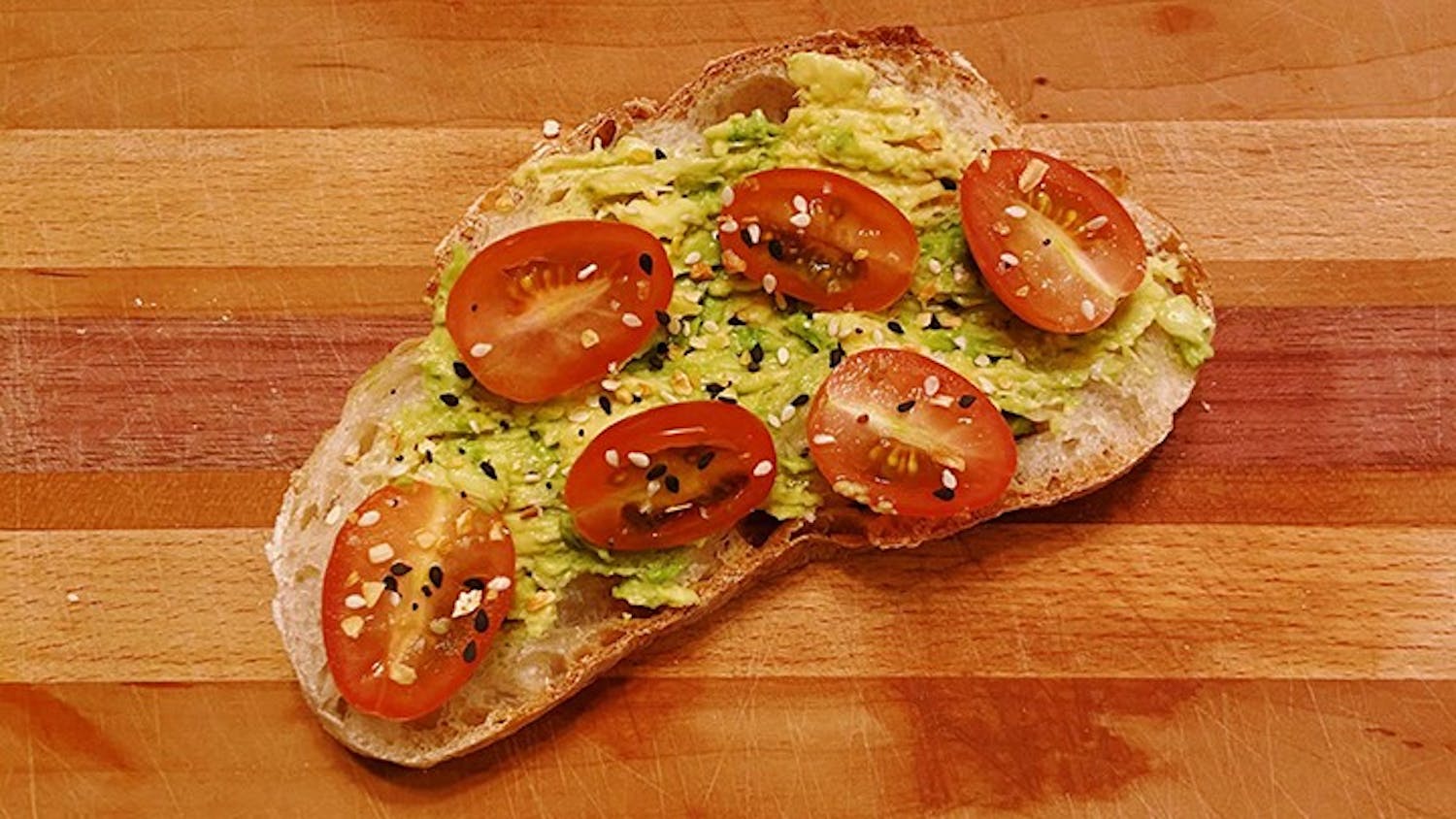 &nbsp;A piece of toast topped with avocado and tomato.&nbsp;