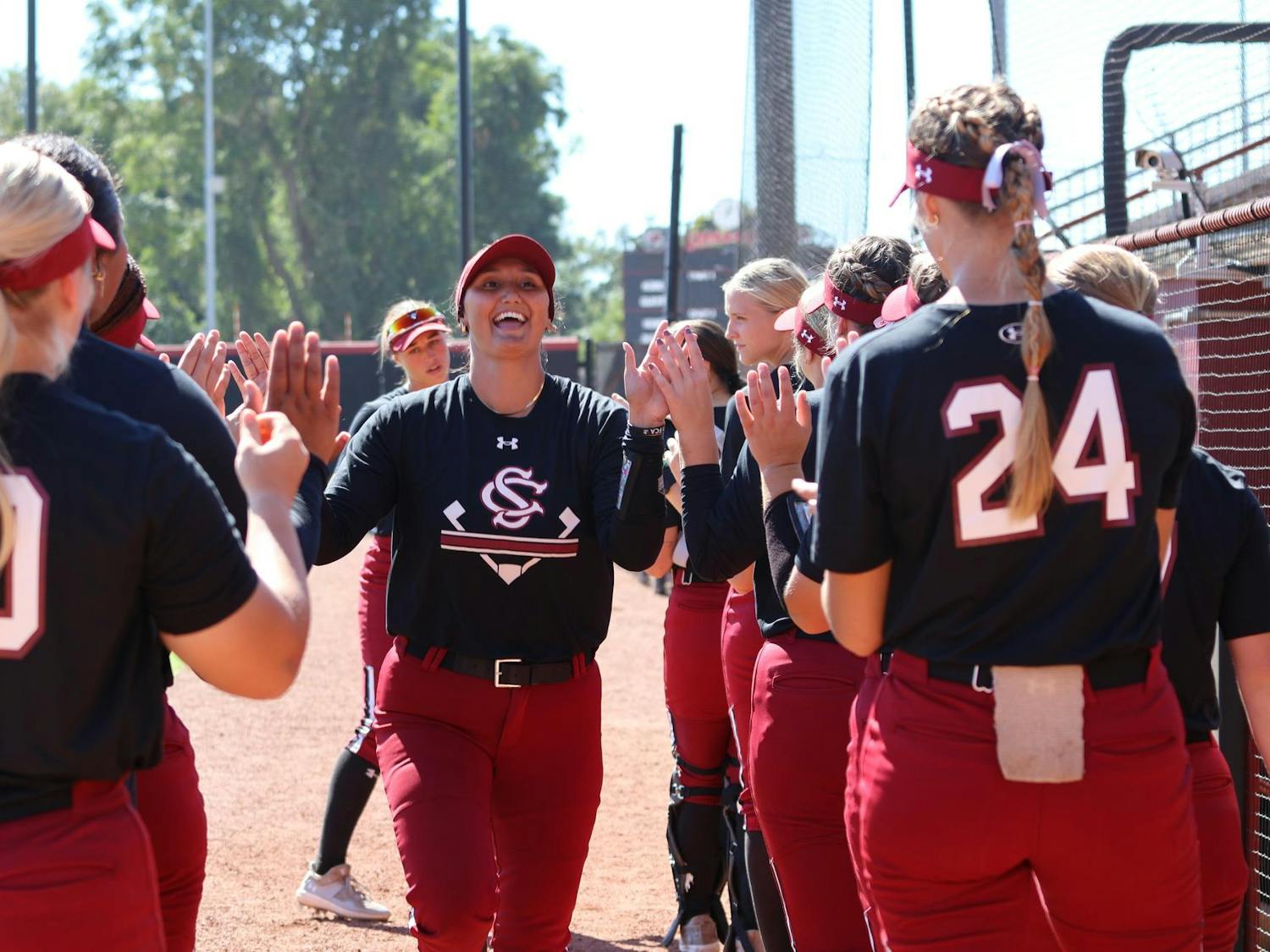 Redshirt sophmore infielder Kiki Estrade high fives her teammates during lineup announcements before South Carolina's exhibition game against USC Aiken on Oct. 12, 2024. The Gamecocks defeated the Pacers 14-1.