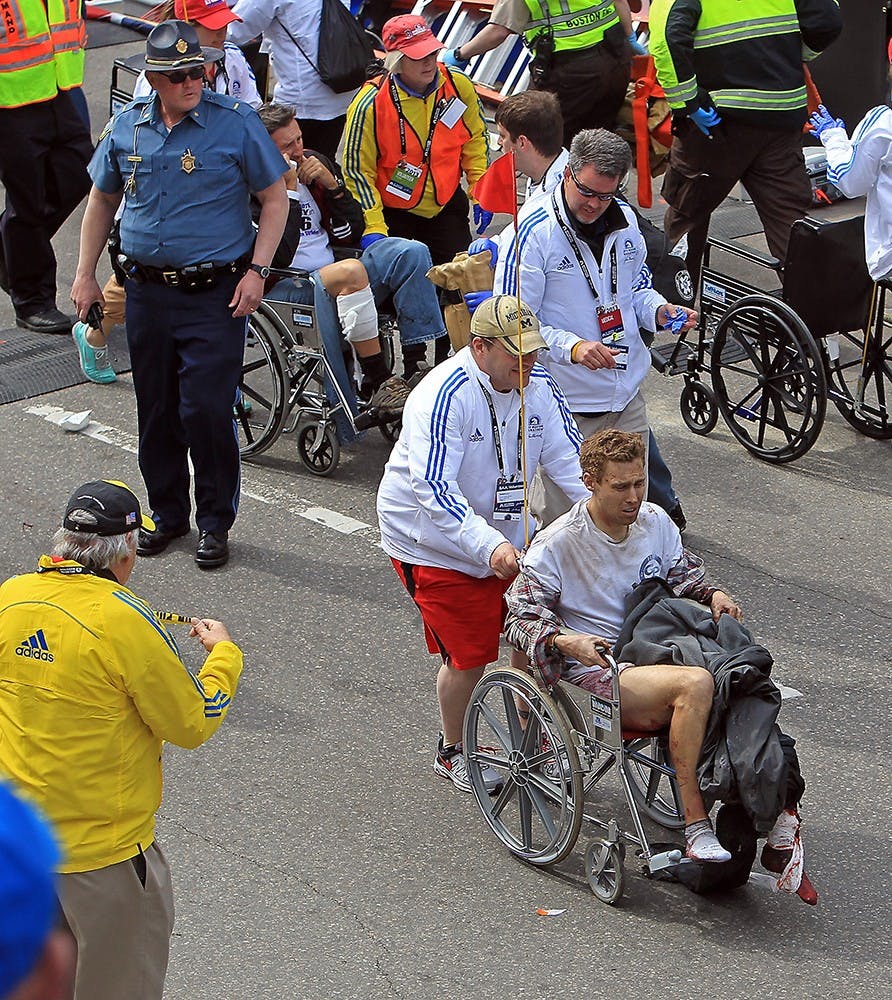 Victims of the bomb blast during the Boston Marathon are assisted in Boston, Massachusetts, Monday, April 15, 2013. (Stuart Cahill/Boston Herald/MCT)