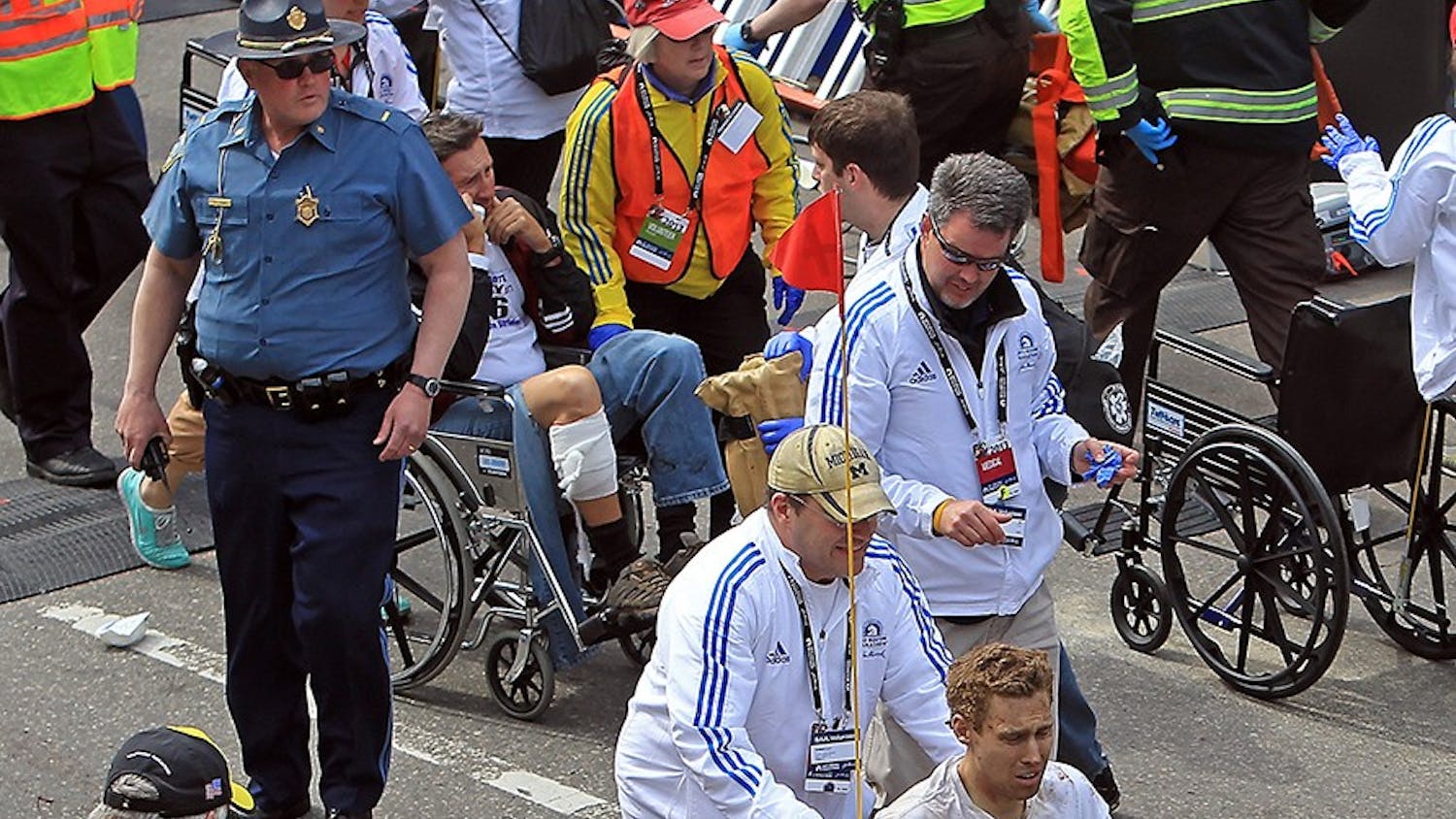 Victims of the bomb blast during the Boston Marathon are assisted in Boston, Massachusetts, Monday, April 15, 2013. (Stuart Cahill/Boston Herald/MCT)