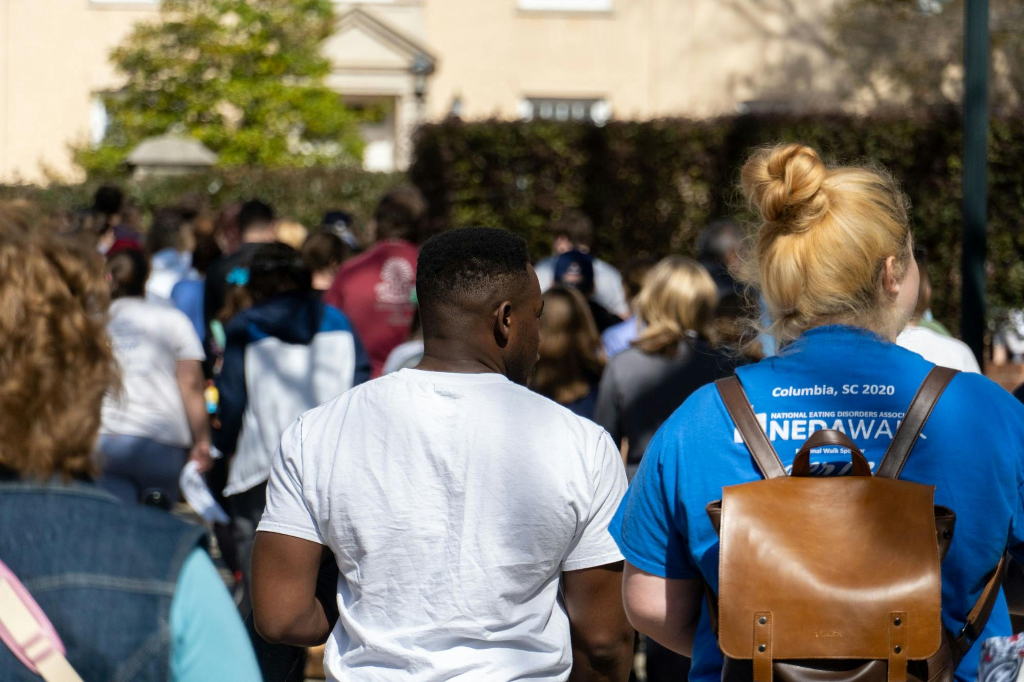 Community members and supporters of NEDA walk across the Carolina campus on Feb. 26, 2022.The NEDA Walk took place as a charity event raise support and money for those who effected by eating disorders.