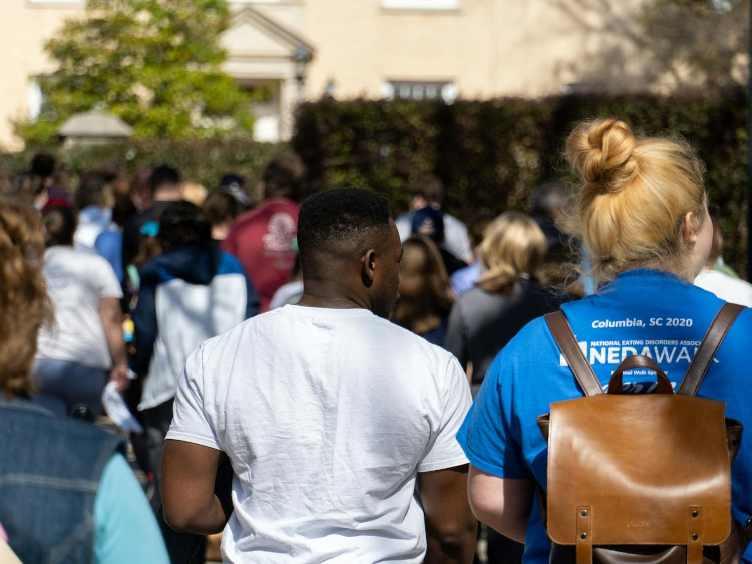 Community members and supporters of NEDA walk across the Carolina campus on Feb. 26, 2022.The NEDA Walk took place as a charity event raise support and money for those who effected by eating disorders.