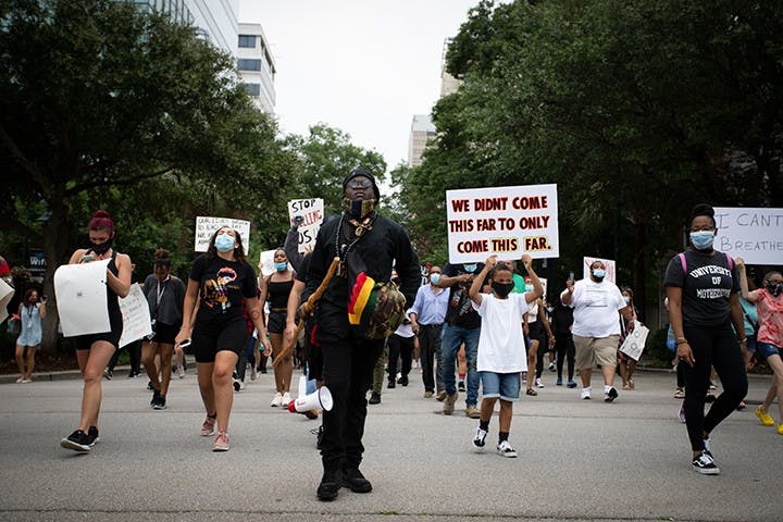 People marching at the “I Can’t Breathe” protest move towards the Statehouse in Columbia on May 30.&nbsp;