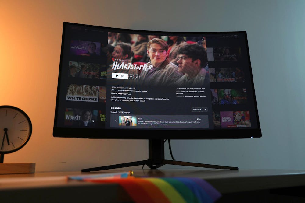 <p>A monitor showing the new season of Heartstopper sits on a desk with a pride flag hanging off the edge. The third series of the popular British romantic comedy show was released on Oct. 3, 2024 and features eight new episodes.</p>