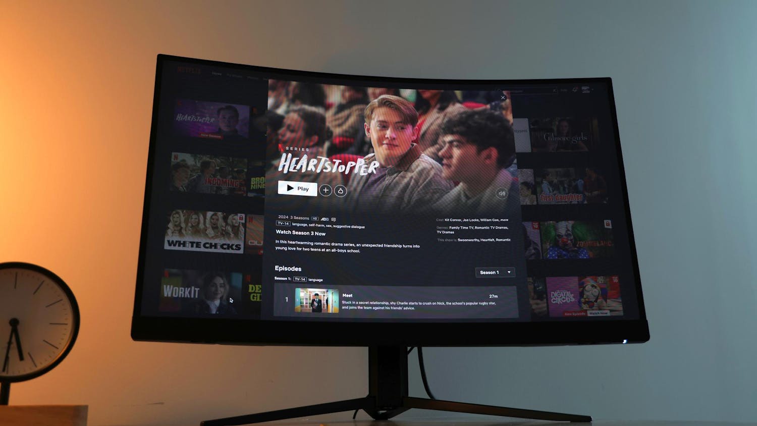A monitor showing the new season of Heartstopper sits on a desk with a pride flag hanging off the edge. The third series of the popular British romantic comedy show was released on Oct. 3, 2024 and features eight new episodes.
