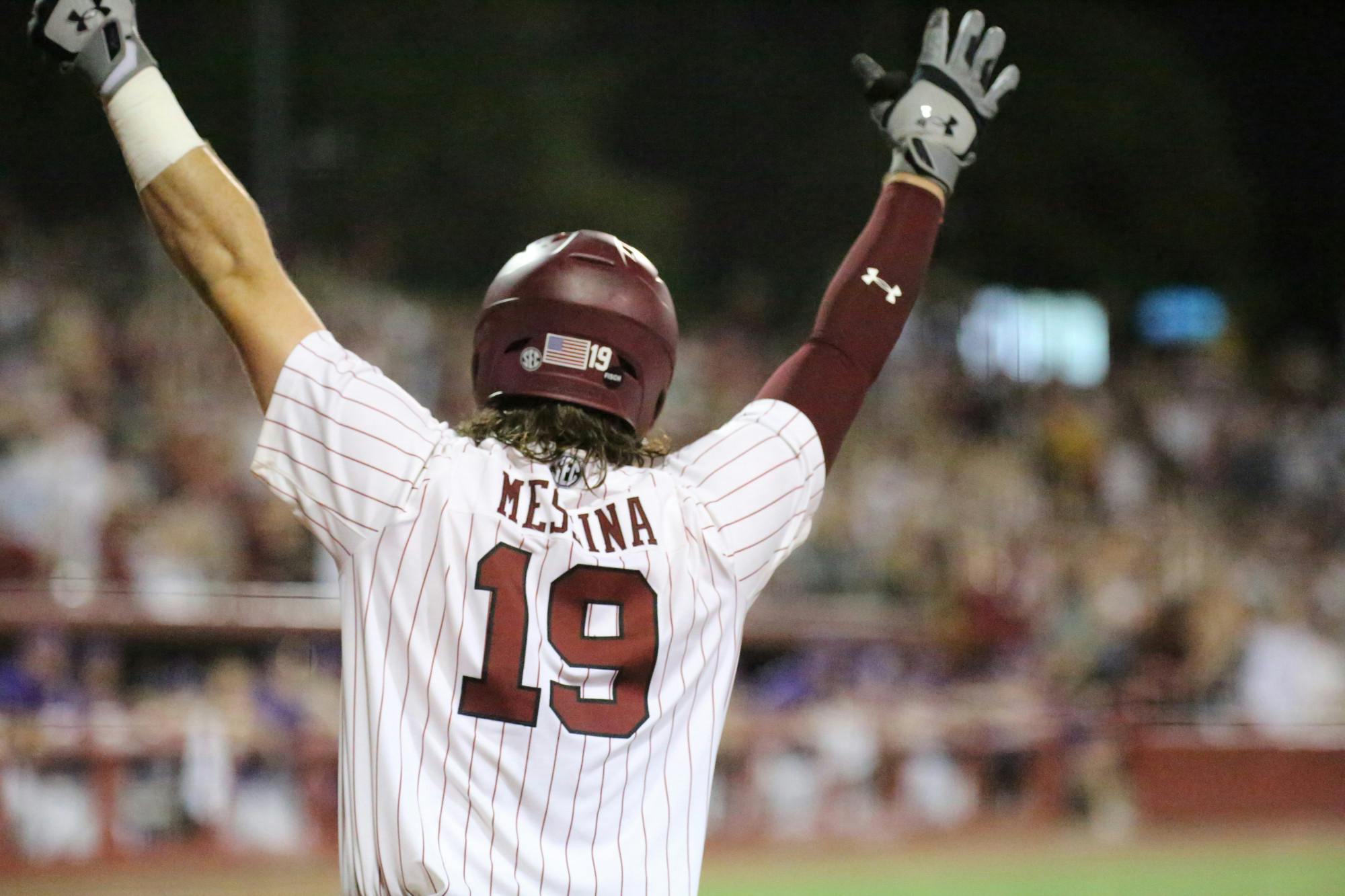 Sophomore catcher Cole Messina throws his hands in the air after freshman outfielder Ethan Petry hits a grand slam for the Gamecocks, expanding its lead against the Tigers. No. 6 South Carolina won the first game of the two-game series 13-5 against No. 1 LSU on April 6, 2023, at Founders Park.&nbsp;