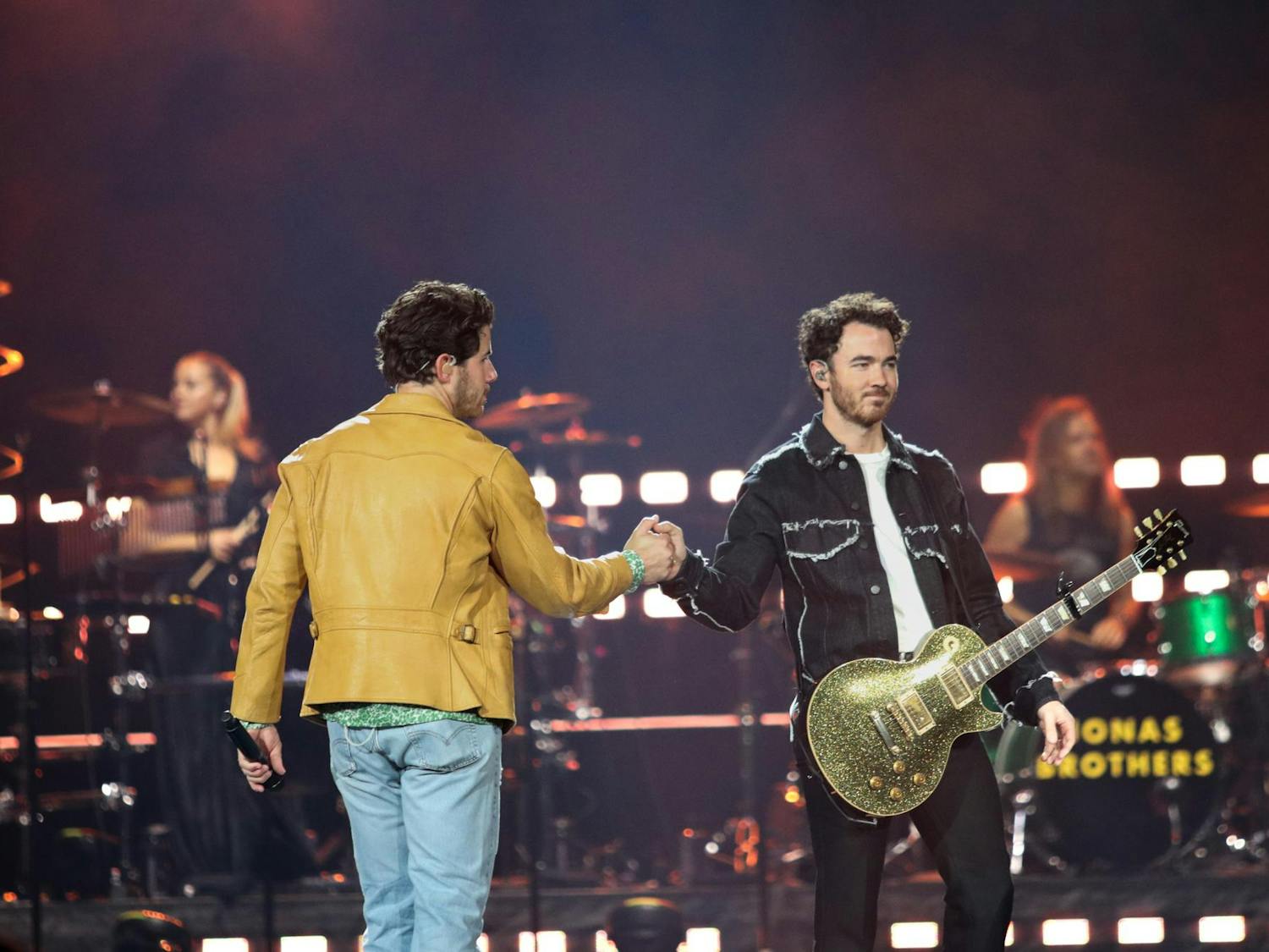 Brothers Nick and Kevin Jonas fist bump during the first song of The Tour at Colonial Life Arena on Oct. 10, 2023. The trio perform over sixty songs, including mash-ups, at each show of The Tour.