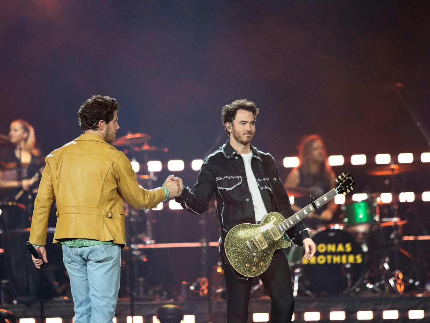 Brothers Nick and Kevin Jonas fist bump during the first song of The Tour at Colonial Life Arena on Oct. 10, 2023. The trio perform over sixty songs, including mash-ups, at each show of The Tour.