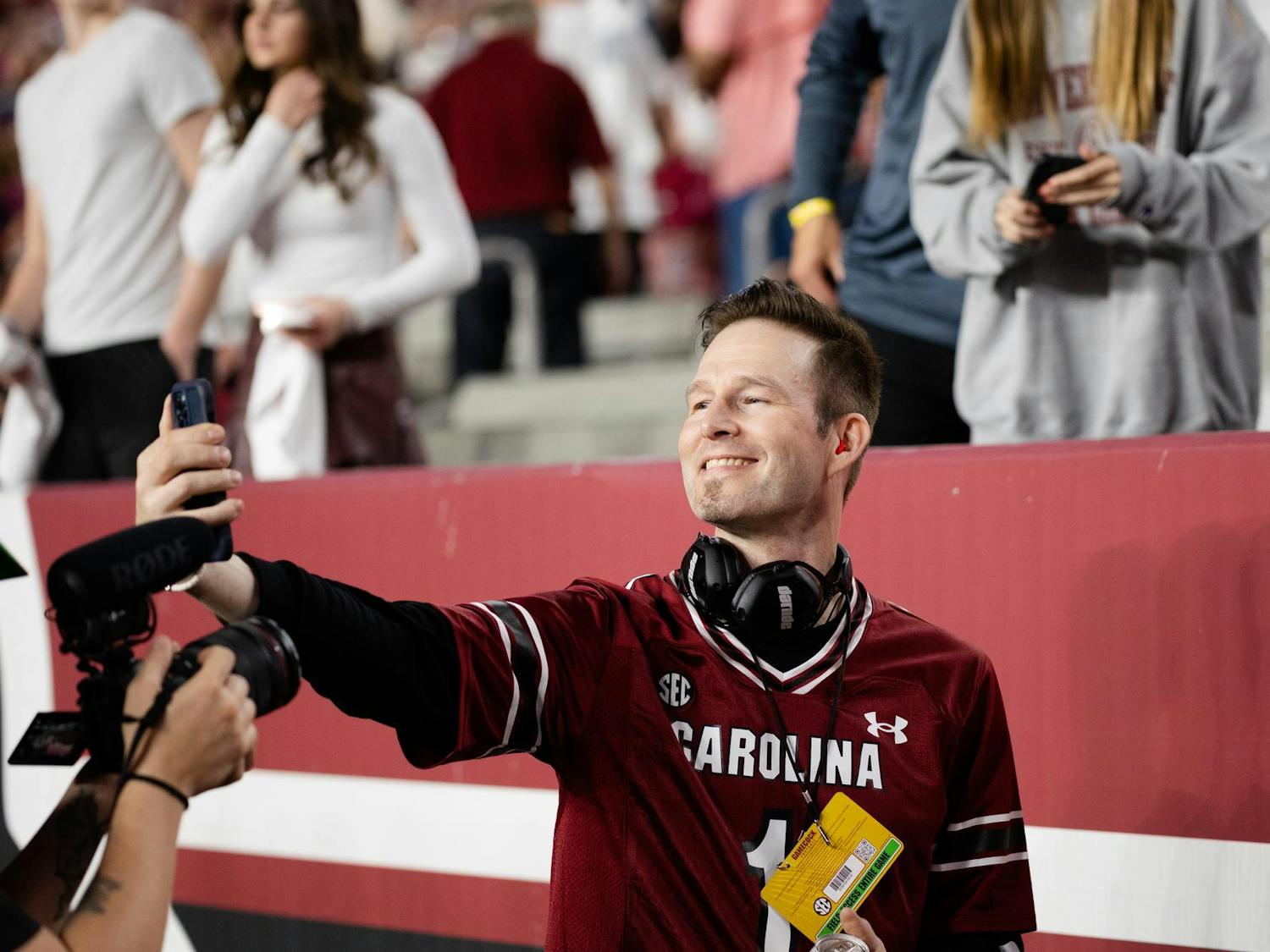Darude smiles for a picture with a fan while on the sidelines of South Carolina's game against Kentucky. The Gamecocks went on to beat the Wildcats 17-14.