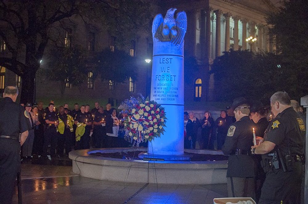 <p>Officers and loved ones of fallen officers gathered at the Fallen Officer Memorial at the Statehouse Tuesday night in remembrance of those lost in the line of duty. </p>