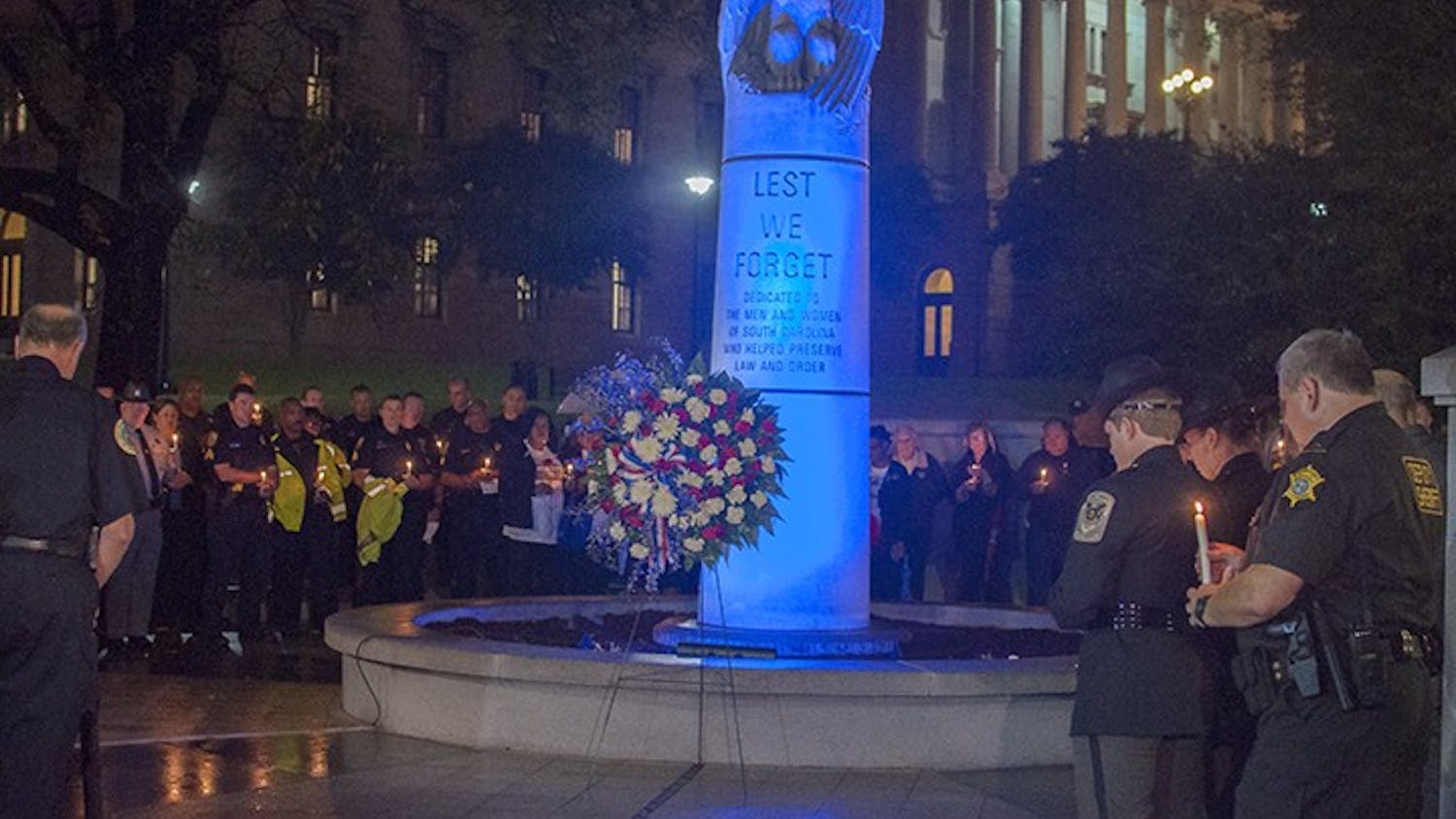 Officers and loved ones of fallen officers gathered at the Fallen Officer Memorial at the Statehouse Tuesday night in remembrance of those lost in the line of duty. 