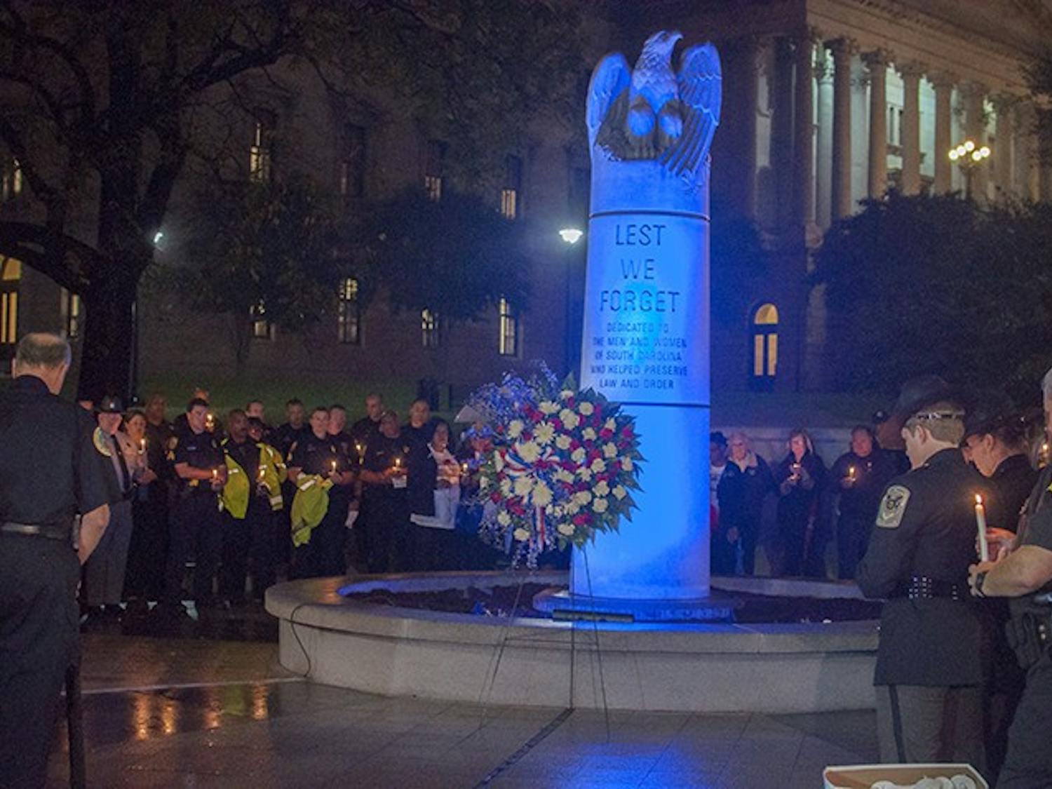 Officers and loved ones of fallen officers gathered at the Fallen Officer Memorial at the Statehouse Tuesday night in remembrance of those lost in the line of duty.