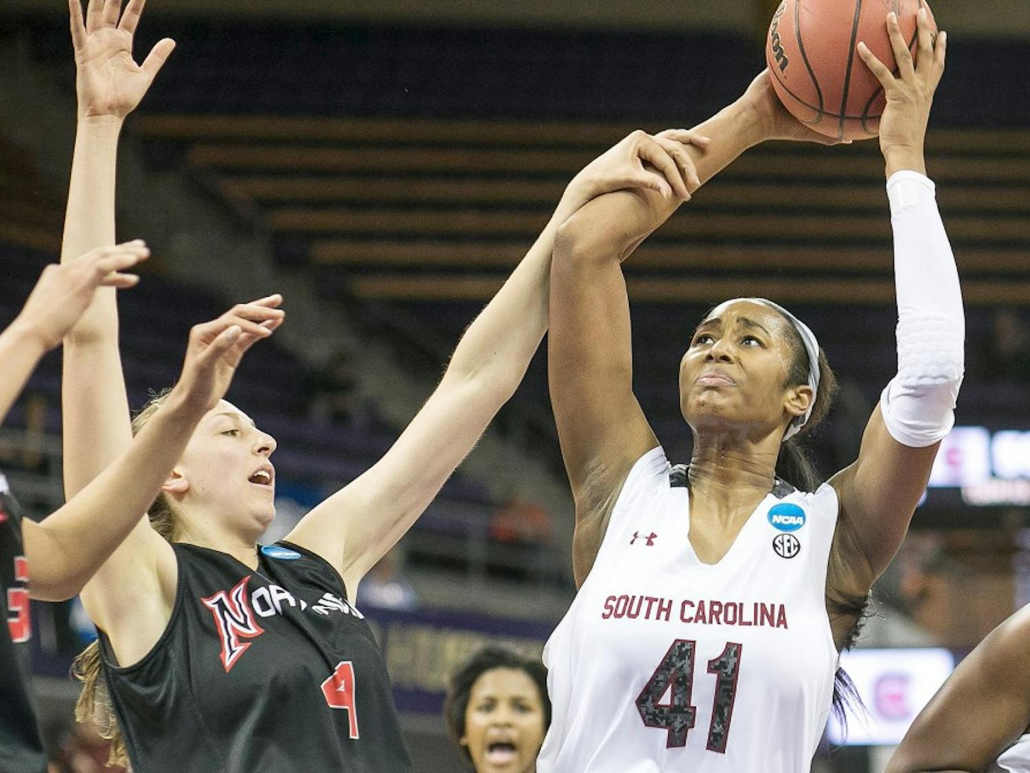South Carolina&apos;s Alaina Coates (41) gets the rebound and attempts the put back in the second half, but gets fouled by CSU Northridge&apos;s Camille Mahlknecht during the first round of the women&apos;s NCAA Tournament in Seattle on Sunday, March 23, 2014. (Dean Rutz/Seattle Times/MCT)