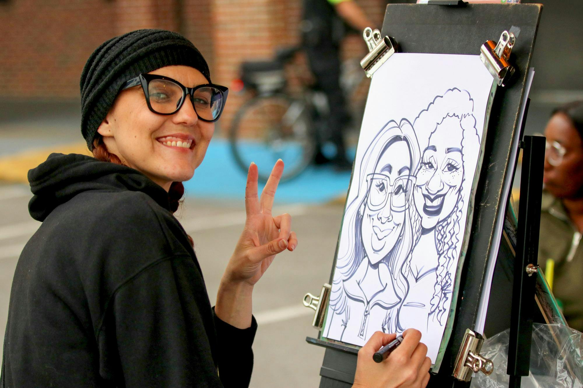 Orlando, Florida, resident Sara Davis draws a caricature of two people at the South Carolina State Fair on Oct. 10, 2025. The fair ran from Oct. 8 to 19.